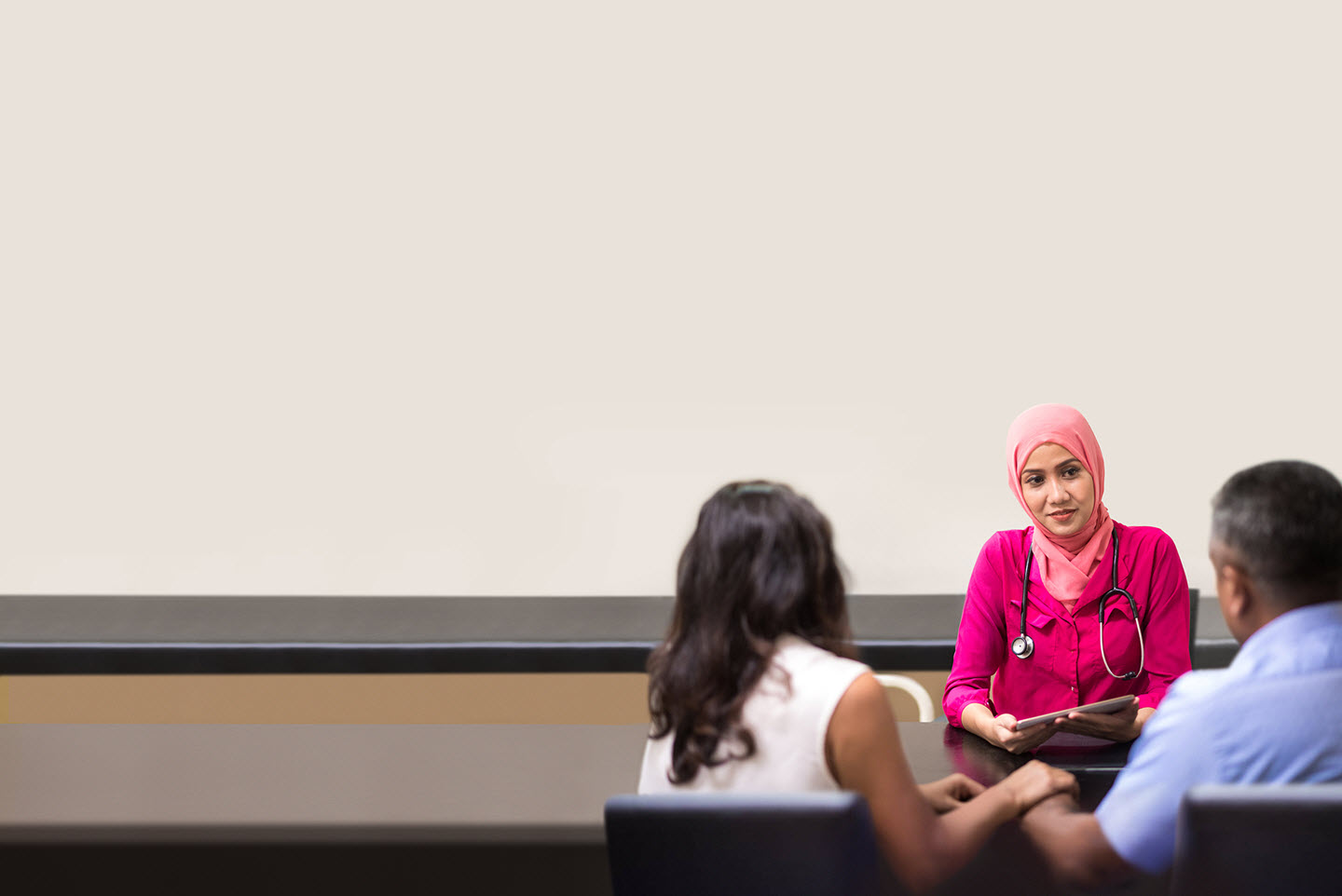 Healthcare provider discussing care plan with patient and caregiver